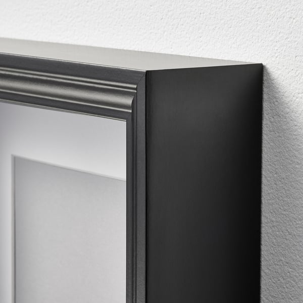 Black-framed mirror/picture on white wall, high-quality craftsmanship.