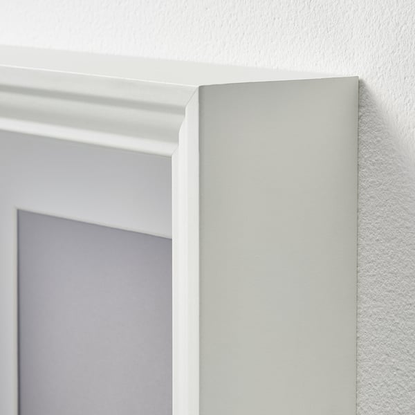 White picture frame with clean, smooth edges; sturdy plastic front protection; neat corner detail.