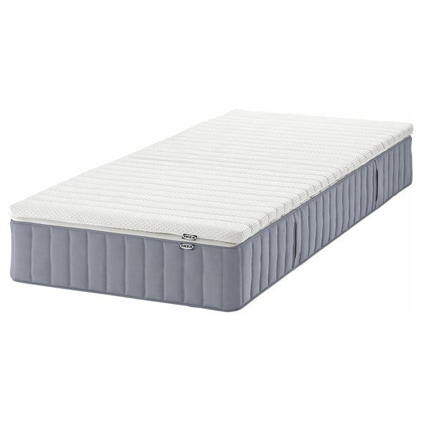 Grey IKEA VALEVÅG pocket spring mattress with white top, modern design for firm support.