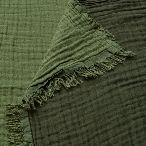 Soft, fringe-edged green throw blanket, crinkled cotton texture.