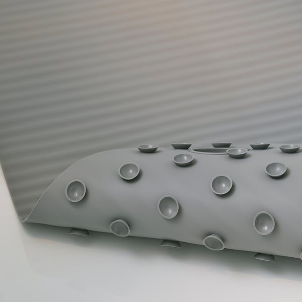 Grey bathtub mat with suction cups, featuring circular design for secure placement and drainage.