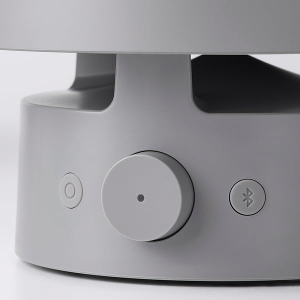 Close-up of VAPPEBY speakers control panel featuring a large dial, power button, and bluetooth button.