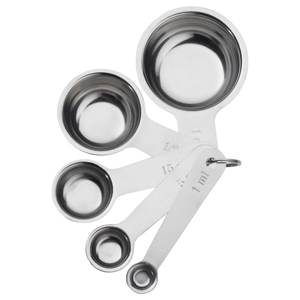 Five stainless steel measuring cups nested together, varying in size, with measurements marked on handles.