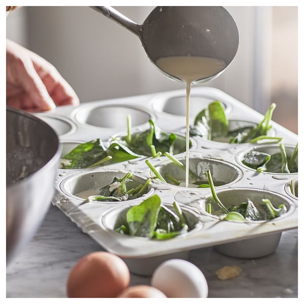 Silver, VARDAGEN muffin tin filled with green veggies; liquid poured.