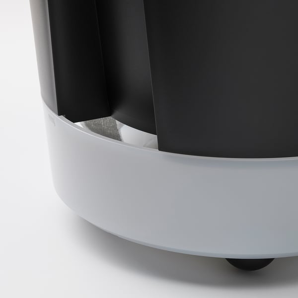 Black self-watering planter with white base and wheels.