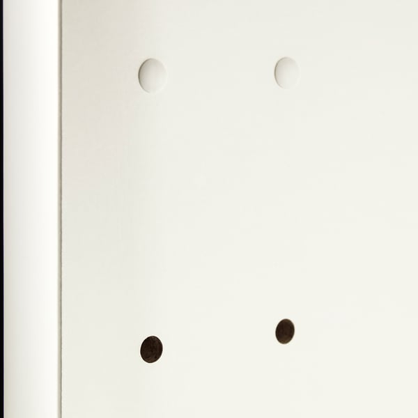 Four circular cover caps, two white, two dark, designed to hide drill holes in cabinetry, ensuring a neat appearance.