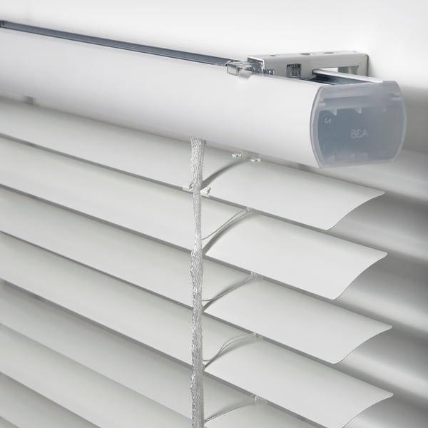Close-up of modern white venetian blinds cord and tilt mechanism, showing high-quality materials and design.