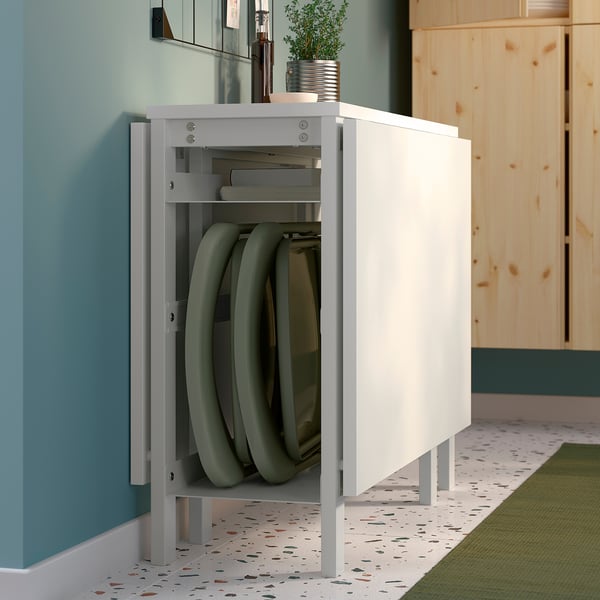 Foldable dining table stores flat, saves space, ideal for small homes.