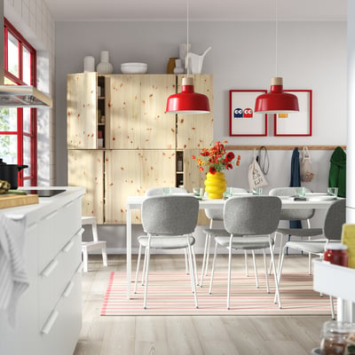 Modern dining area with VIHALS table & chairs, wooden cabinets, red accents, minimalist design.