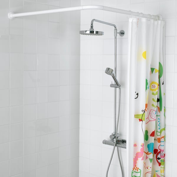 Modern shower with rainfall head, handshower, and colourful curtain.