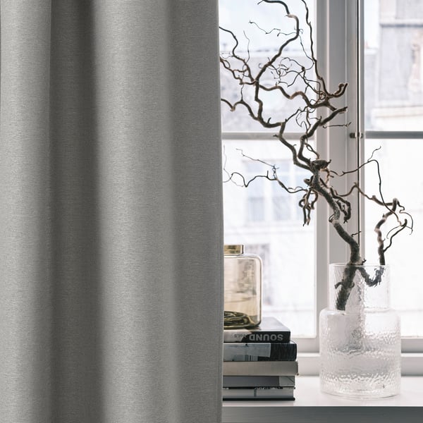 VILBORG grey curtains darken room, linear design, tall, vase with branch, books, insulates, modern.