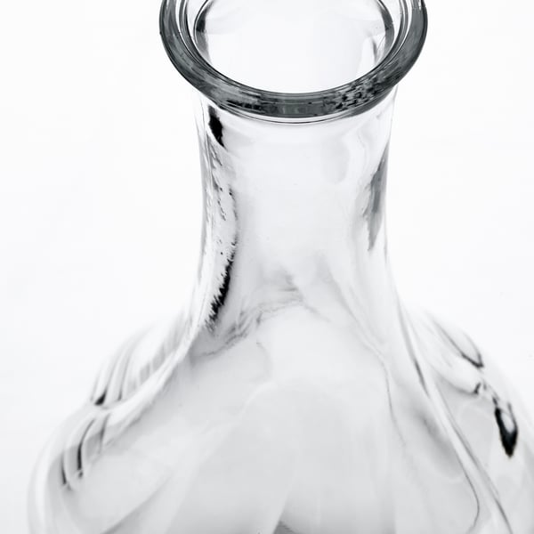 Glass vase, clear with subtle texture, simple yet elegant design.
