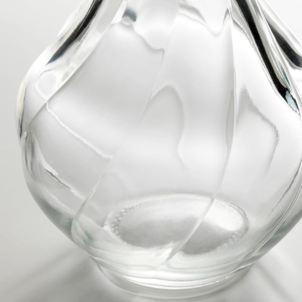 Clear glass vase, elegantly textured, stands alone, refined & delicate.