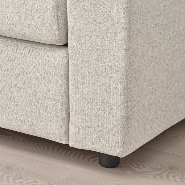 Light grey fabric sofa close-up, showing plush cushions and sturdy black legs, highlighting comfort and modern design.