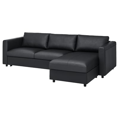 Black leather l-shaped sofa with deep seats and armrests, perfect for lounging.