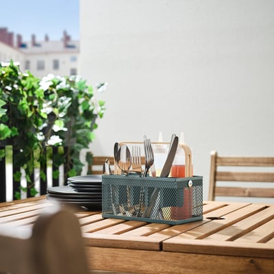 VIMPELFISK cutlery holder on table, small, green, bamboo handle, mesh design, stores utensils near plates.