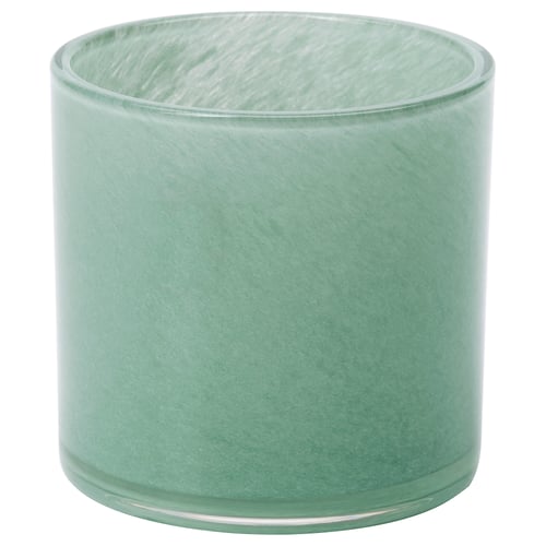 Green glass cylindrical tealight holder with textured design.