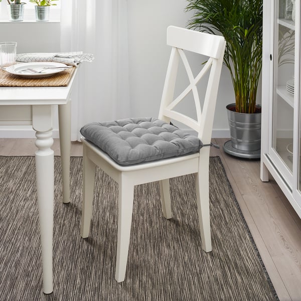 White plush seat chair pad for dining chair, elegant comfort.