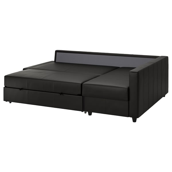 Juoda sofa-lova FRIHETEN su daiktadėže, aptakus modernus dizainas, odą primenantis palto audinys.