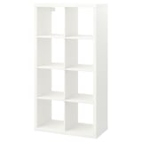 Белая книжная полка KALLAX cube с открытыми отделениями для хранения.