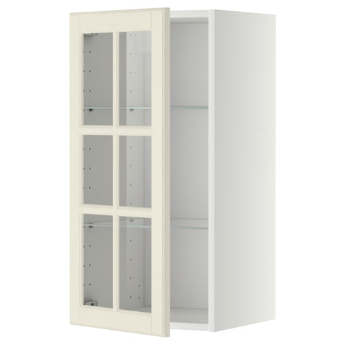 На этом изображении показан белый кухонный шкаф ikea METOD с четырьмя стеклянными дверцами в традиционном дизайне со скошенными краями.