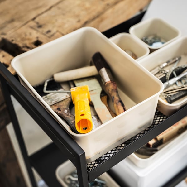 Белые пластиковые коробки NOJIG для хранения инструментов для рисования на черной металлической полке.