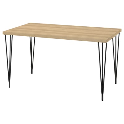 A SKÅLSTA table. Столешница из светлого дерева, ножки из черного металла, прямоугольная форма с элегантным дизайном.