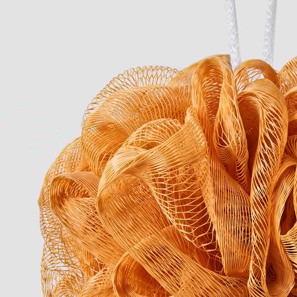 Orange mesh body puff for exfoliation, hanging loop visible, finer mesh detail noticeable.