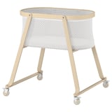 Beige ÄLSKVÄRD bassinet with mesh, wheels, wood & fabric.