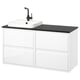 A modern, white ÄNGSJÖN vanity set with a black countertop and sink, featuring sleek drawers for storage.