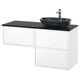 Modern white bathroom vanity with three drawers, black marble countertop, and oval black glass basin.