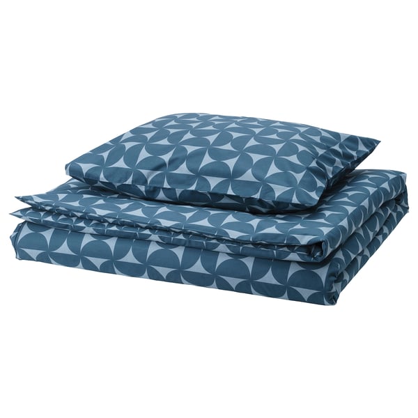 Blue geometric bedding set; square pillows, rounded shapes.