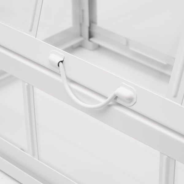 White metal-framed greenhouse with plastic handles and support bars, ensuring stability and durability for indoor or outdoor plant growth.