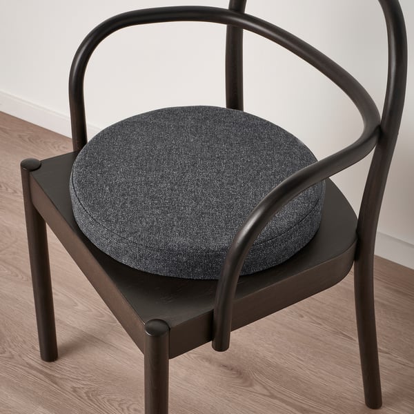 Modern chair with round, cushioned seat and curved armrests, providing comfort and style.