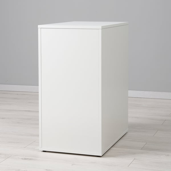 A sleek, modern, white cube storage unit with a clean finish, standing alone on a light wooden floor.