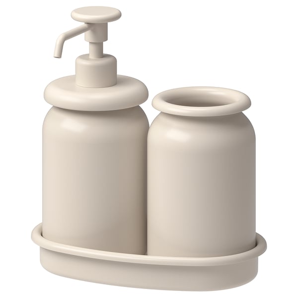 A beige ÅLTJÄRN bathroom set. It includes a soap dispenser and a toothbrush holder, both with rounded edges, placed in a matching tray.