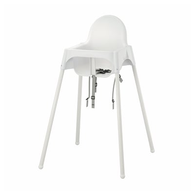 White plastic highchair with four legs and adjustable straps.