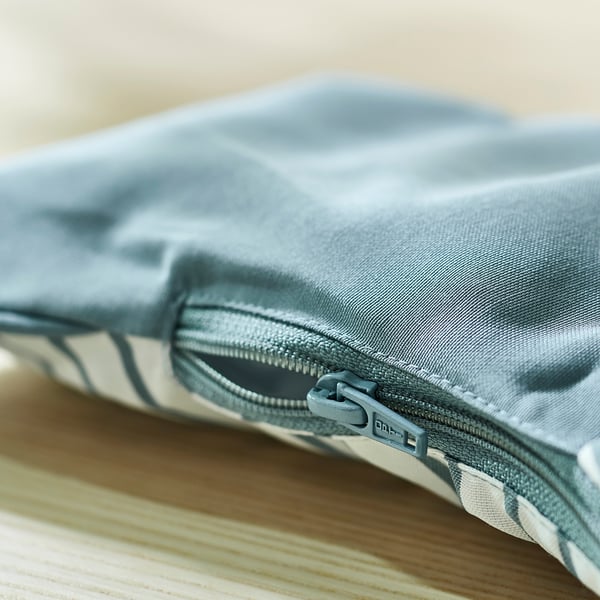 Close-up of a grey zip on a reversible, inflatable baby support cushion.