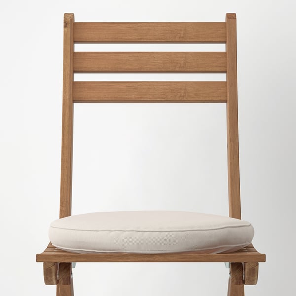 Modern wooden chair with beige cushion, three back slats, sturdy supports.