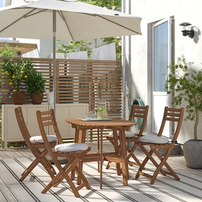 Cosy patio with ASKHOLMEN table & chairs, cushions, umbrella on deck. Great for small spaces.