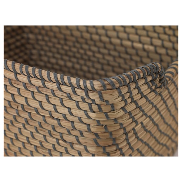 Close-up of intricately woven seagrass basket, showcasing detailed craftsmanship and natural material texture.