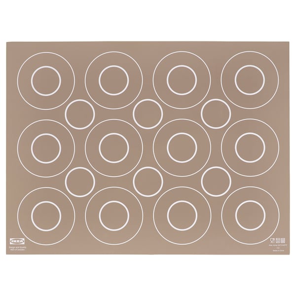 Brown ikea BAKTRADITION silicone baking mat with large white circle cutouts for even baking.