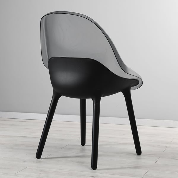 Modern chair with sleek, transparent seat on sturdy beech legs; designed for comfort.