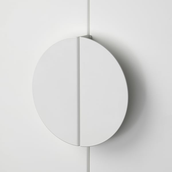 Sleek, white circular handle; smooth edges; minimalist design.