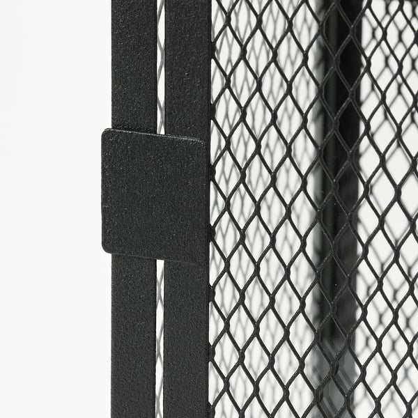 Close-up of a metal mesh lantern. Thick frame holds diamond-patterned net. Quality texture, robust design.