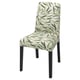 BERGMUND chair with green leafy pattern on beige, wooden legs.