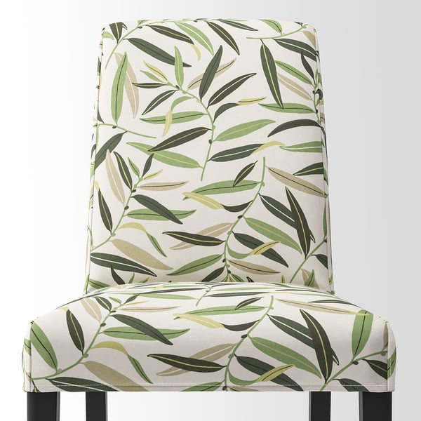 Elegant chair with tropical leaf pattern, high back, sturdy wooden legs, offering comfort and style.