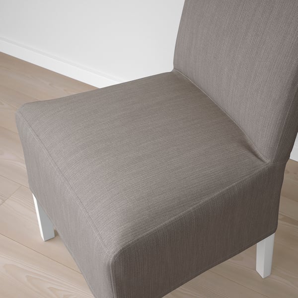 Close-up of a modern, upholstered chair in grey fabric on a wooden floor, showcasing its stylish design and comfortable, supportive backrest.