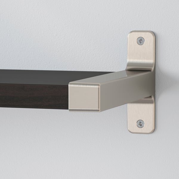 Wall-mounted shelf with metal bracket. Shelf has one bevelled edge, well-secured with screws. Neutral-colored wall in background.