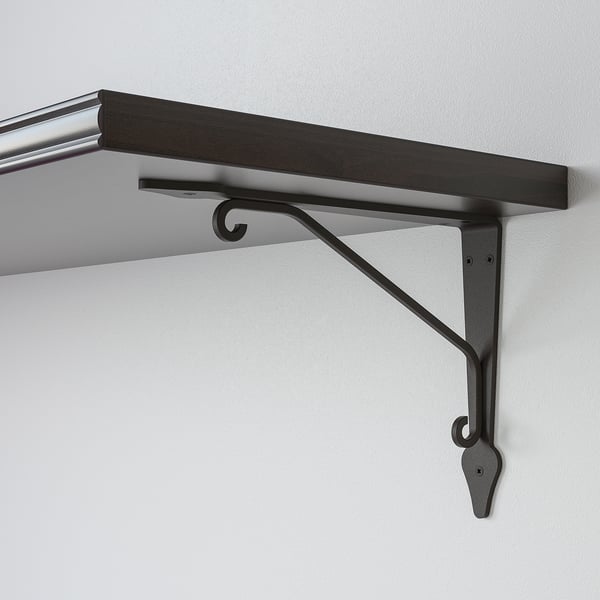 Black metal bracket supports dark wooden shelf against a light wall. Sturdy, minimalist design.